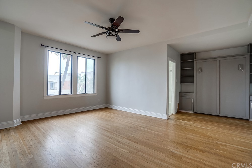 315 West 3rd Street, Unit 507 Long Beach, CA 90802 - Photo 7 of 25 a view of an empty room with wooden floor and a window