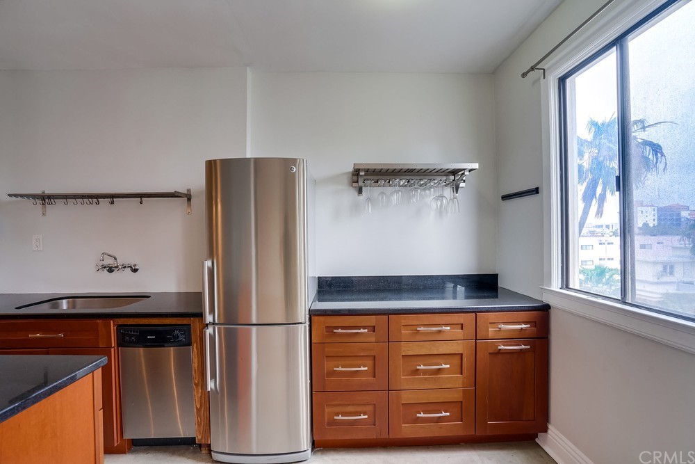 315 West 3rd Street, Unit 507 Long Beach, CA 90802 - Photo 9 of 25 a kitchen with stainless steel appliances granite countertop a refrigerator and a stove