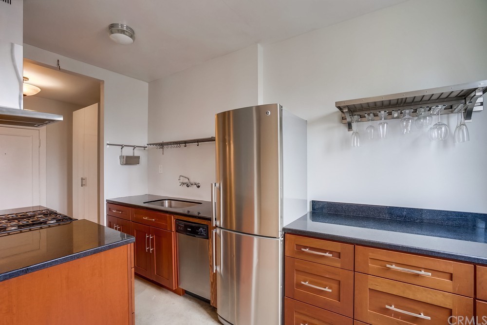 315 West 3rd Street, Unit 507 Long Beach, CA 90802 - Photo 10 of 25 a kitchen with stainless steel appliances granite countertop a refrigerator and a stove