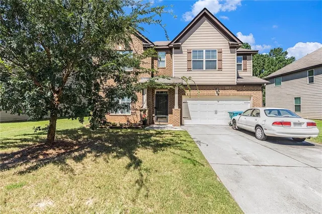 a front view of a house with a yard
