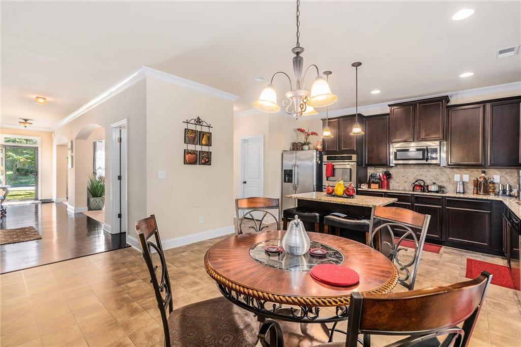 1419 Stone Ridge Court Hampton, GA 30228 - Photo 11 of 31 a open dining room with kitchen island furniture a chandelier and kitchen view