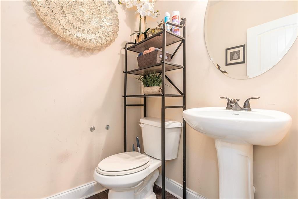 1419 Stone Ridge Court Hampton, GA 30228 - Photo 17 of 31 a bathroom with a sink toilet and mirror