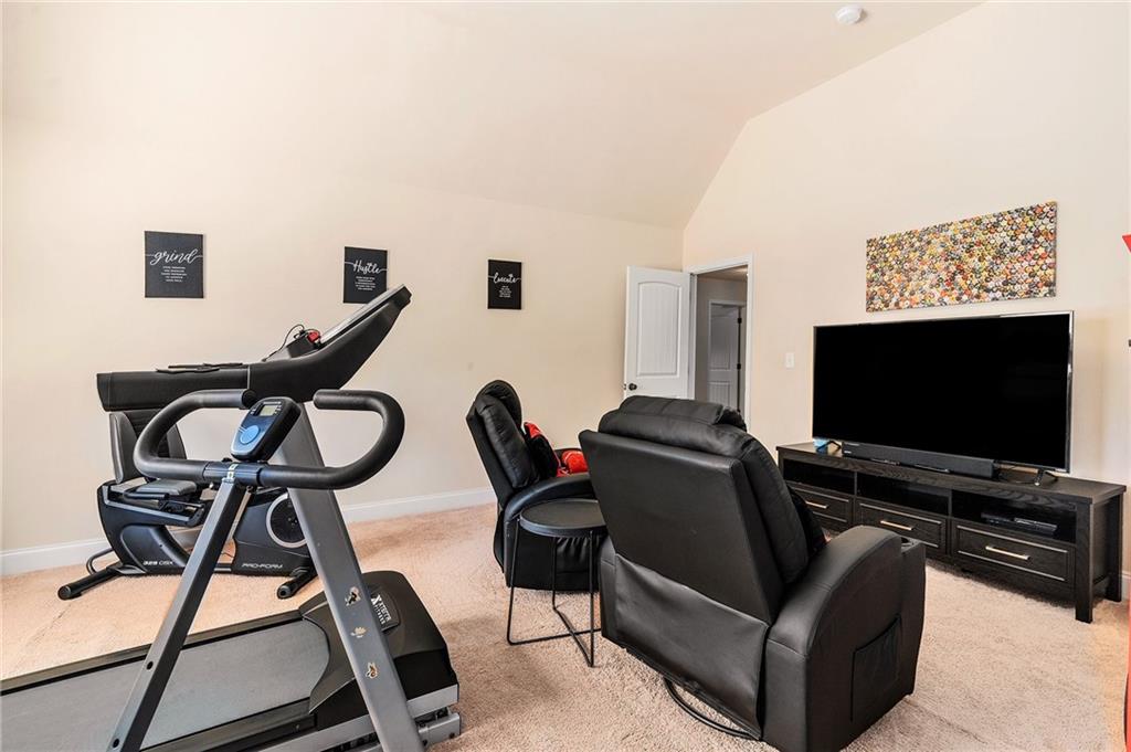 1419 Stone Ridge Court Hampton, GA 30228 - Photo 24 of 31 a living room with furniture and a flat screen tv