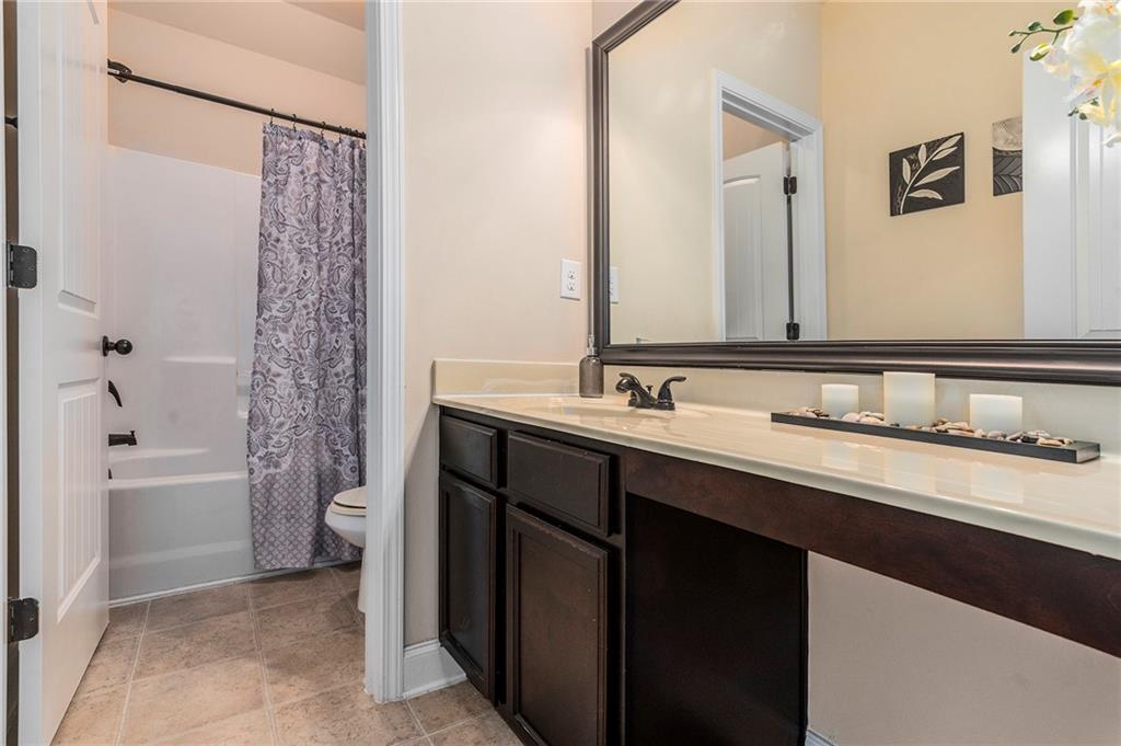 1419 Stone Ridge Court Hampton, GA 30228 - Photo 25 of 31 a bathroom with a double vanity sink a toilet and a bathtub