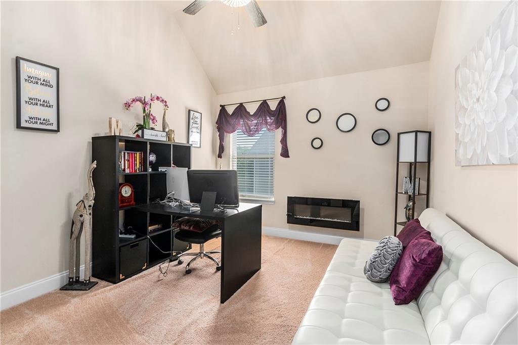 1419 Stone Ridge Court Hampton, GA 30228 - Photo 28 of 31 a living room with furniture and a fireplace