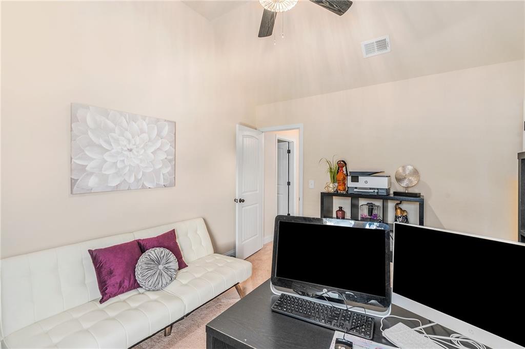 1419 Stone Ridge Court Hampton, GA 30228 - Photo 29 of 31 a living room with furniture and a flat screen tv