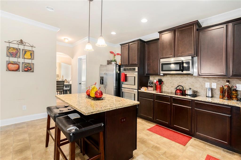1419 Stone Ridge Court Hampton, GA 30228 - Photo 8 of 31 a kitchen with a refrigerator a microwave and stove