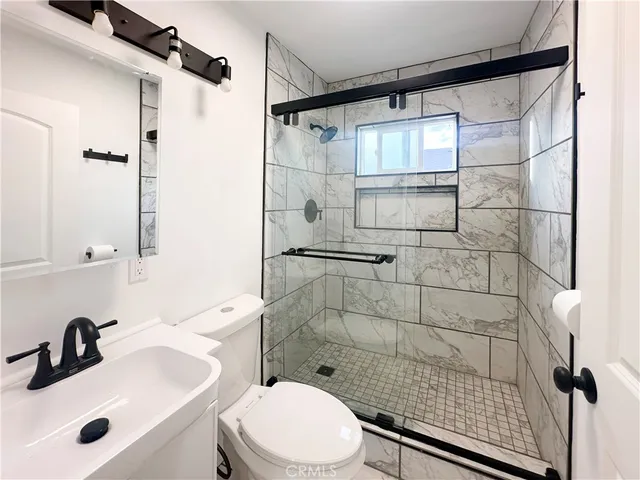 a bathroom with a sink toilet and shower