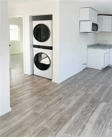 a view of a kitchen with stainless steel appliances granite countertop a sink and a stove top oven