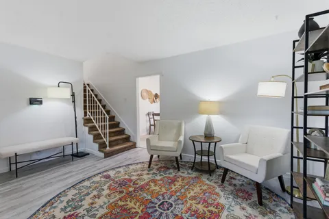 a living room with furniture and wooden floor