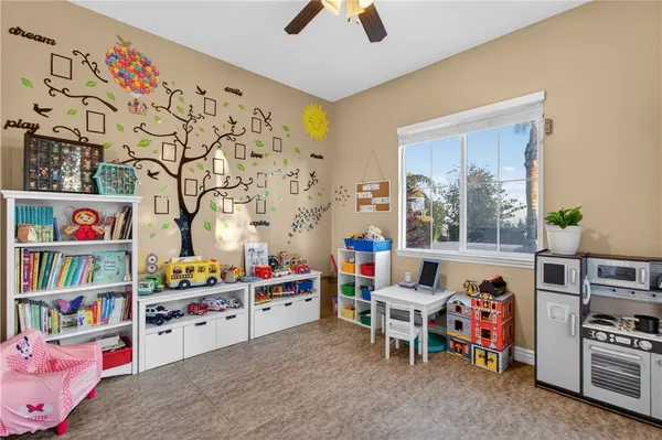 a living room with furniture kitchen view and a large window