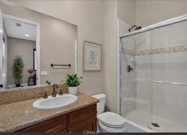 a large spacious bathroom with a granite countertop tub shower and sink