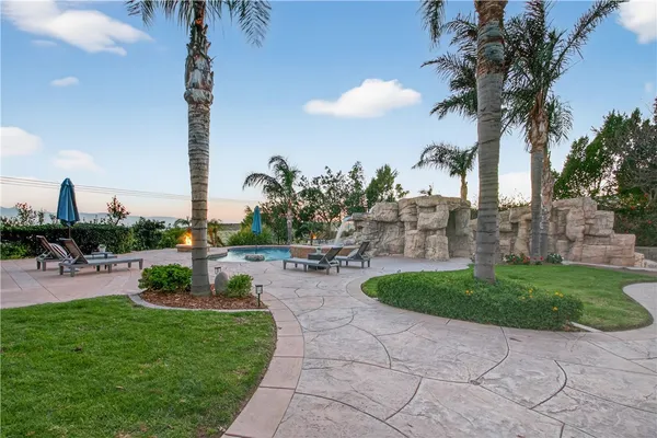 a view of a house with swimming pool and sitting area