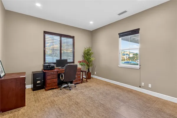 a view of a workspace with furniture and a window