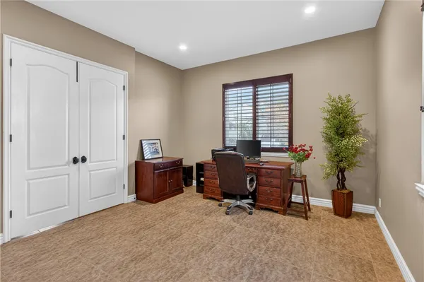 a bathroom with a granite countertop sink toilet a mirror a shower and a mirror