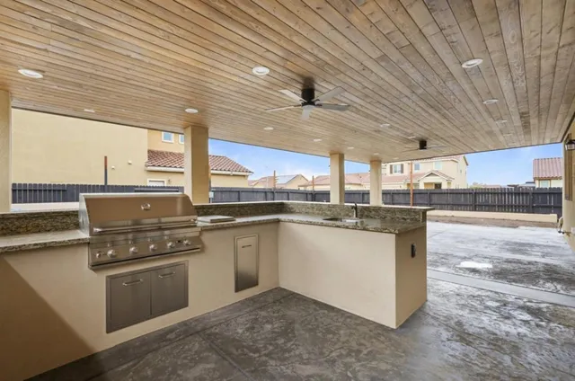 a kitchen with stainless steel appliances granite countertop a stove a sink and a refrigerator