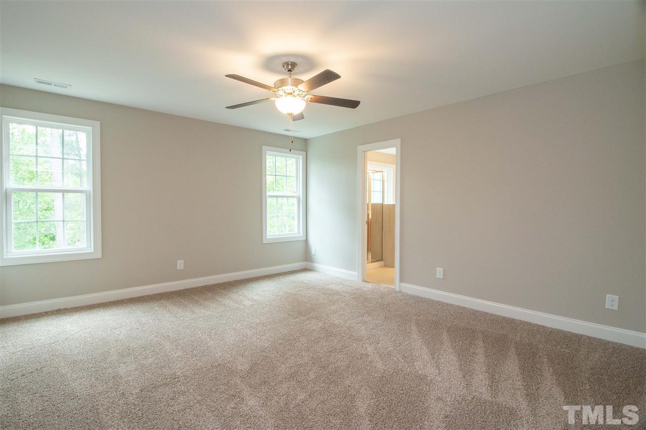 4202 Prelude Street Raleigh, NC 27616 - Photo 13 of 21 Large master suite overlooks private, wooded back yard and has tons of natural light, ceiling fan, and wic