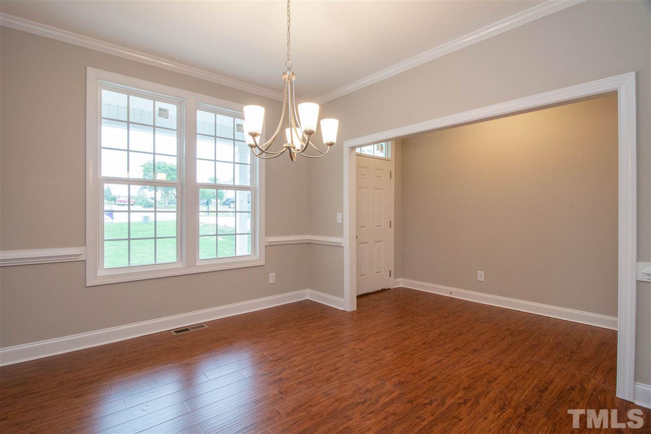 4202 Prelude Street Raleigh, NC 27616 - Photo 4 of 21 Dining room with extra trim, hardwood, and double windows