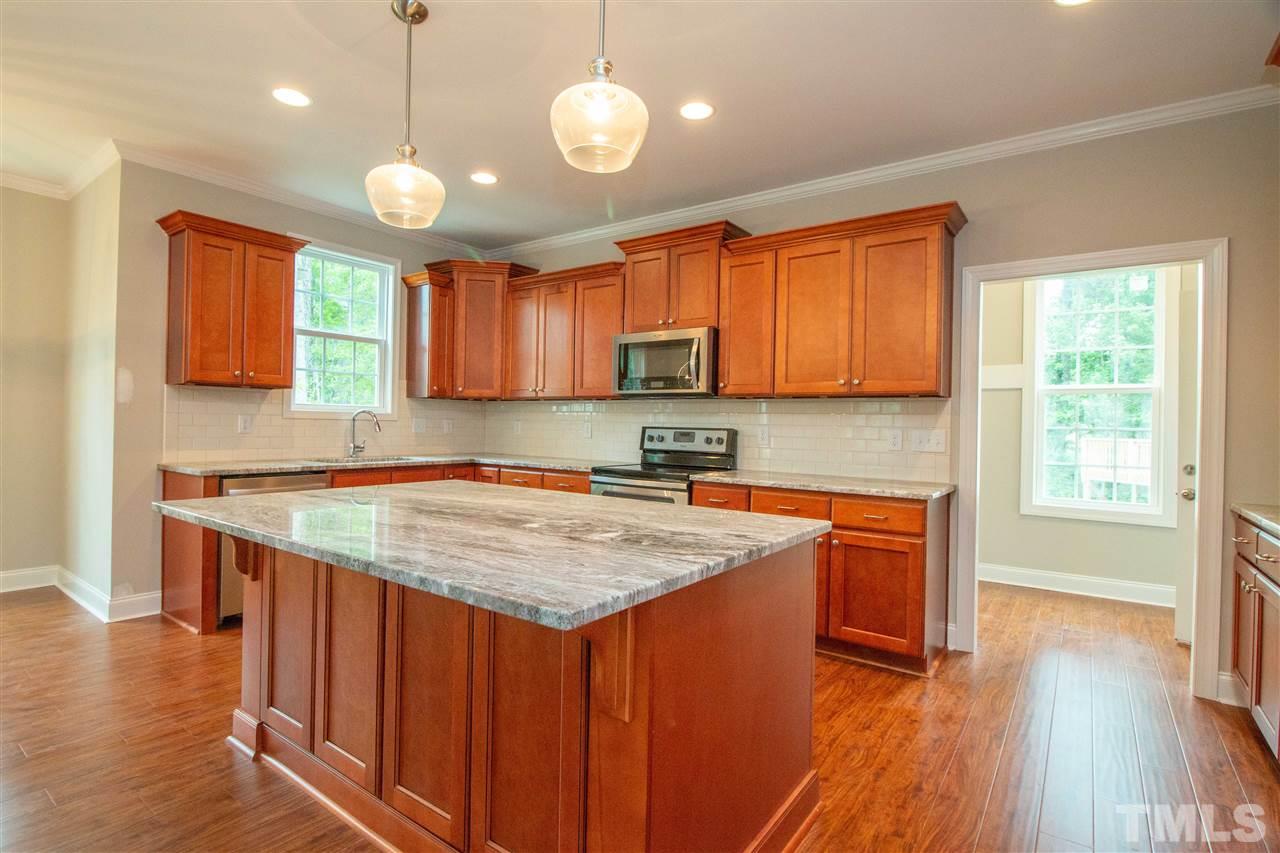 4202 Prelude Street Raleigh, NC 27616 - Photo 7 of 21 Tile backsplash, mocha creme cabinets with glazing & crown