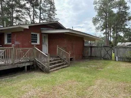 a view of backyard with deck and wooden floor
