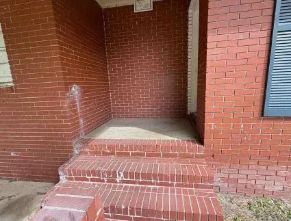 a view of a brick wall with wooden floor