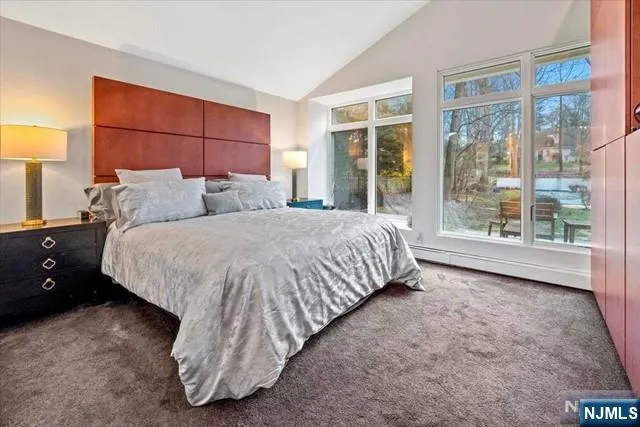 a bed sitting in a room next to a window