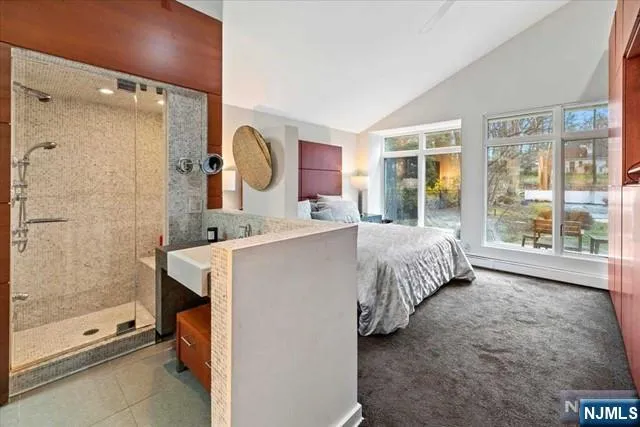 a bed room with a bed and a large window