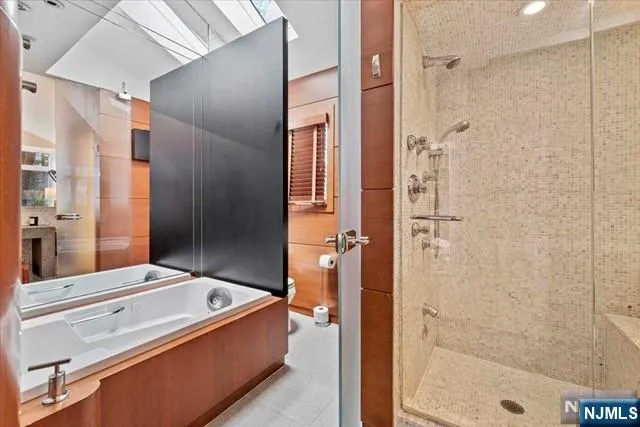 a bathroom with a tub shower and sink