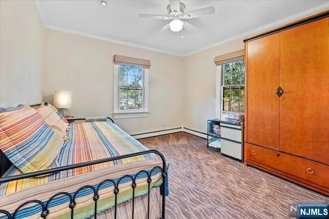 a living room with a bed furniture and a window