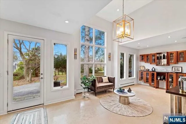 a living room with furniture a window and a chandelier