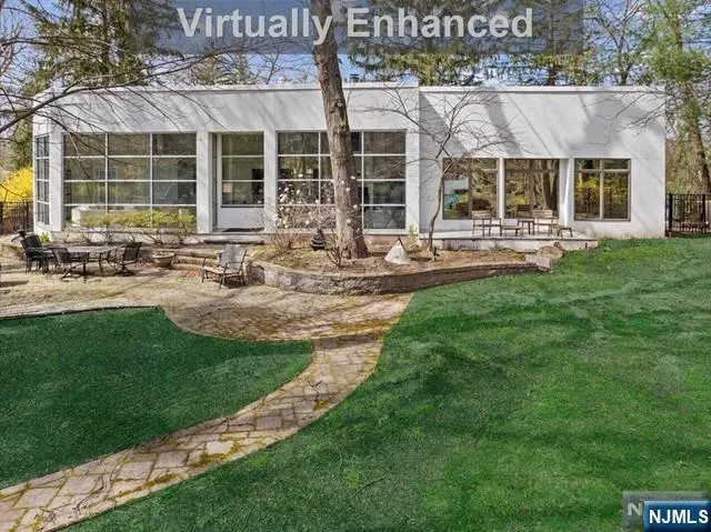 a view of a house with backyard porch and sitting area