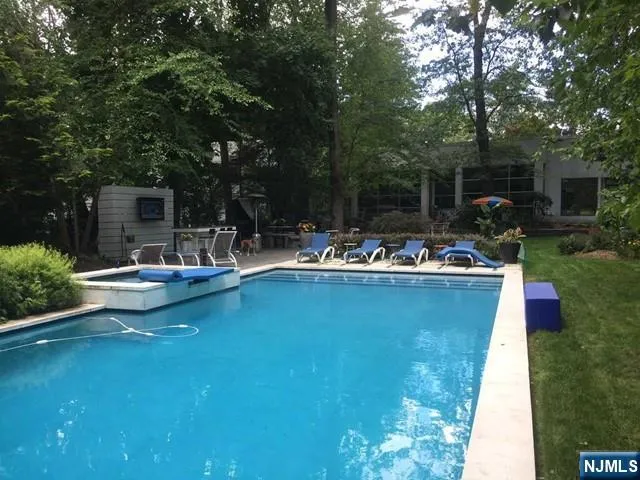 a view of a swimming pool with chairs