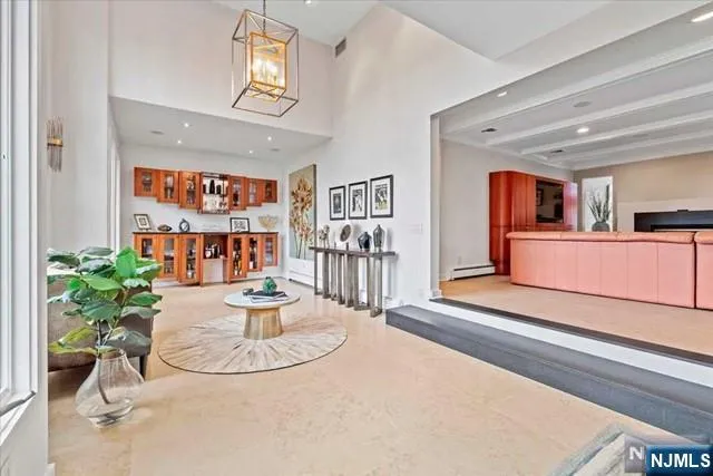 a living room with fireplace furniture and a potted plant