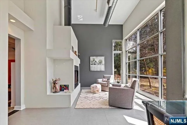 a living room with furniture and a floor to ceiling window