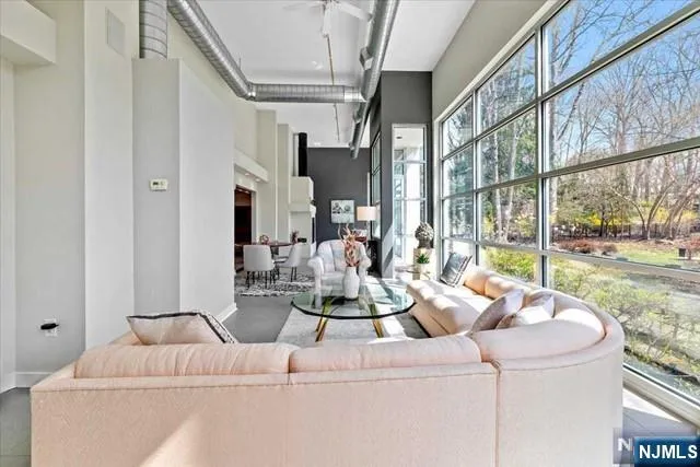 a living room with furniture and a floor to ceiling window