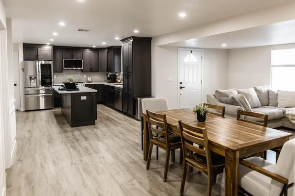 a large kitchen with a table and chairs