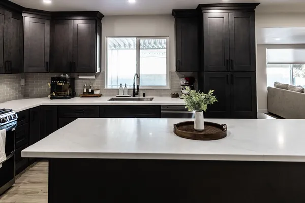 a kitchen with a sink a counter and cabinets