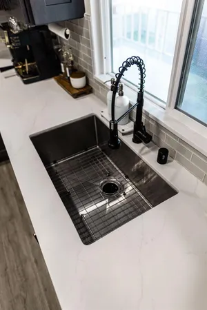 a kitchen with a sink and a refrigerator