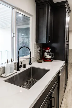 a kitchen with a refrigerator and a sink