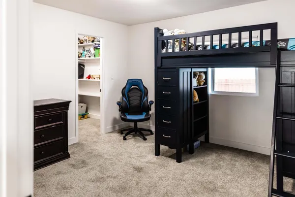 a bedroom with a bed and a dresser