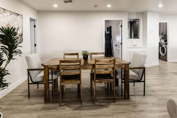 a view of a dining room with furniture and wooden floor