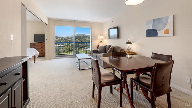 a view of a dining room with furniture window and outside view