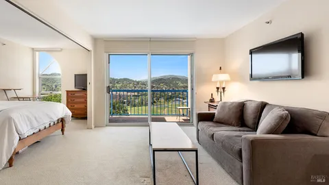 a living room with furniture large window and a flat screen tv