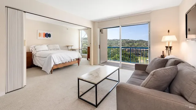 a bedroom with furniture and a window
