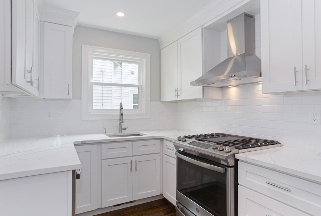 34 Brookvale Street Boston, MA 02124 - Photo 11 of 36 a kitchen with stainless steel appliances white cabinets and a sink
