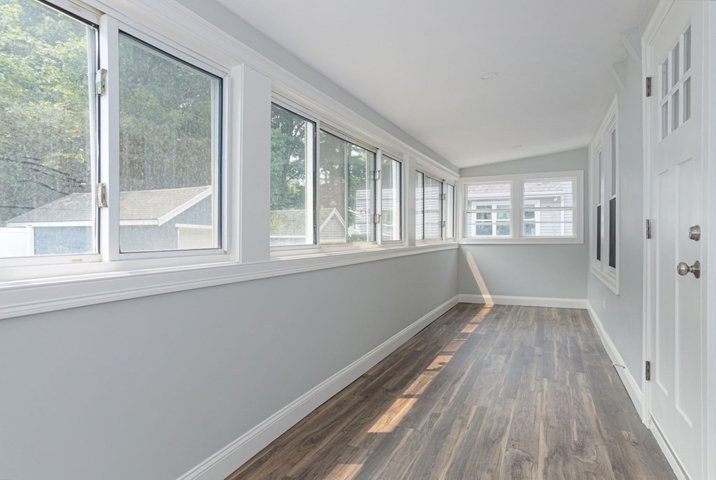 34 Brookvale Street Boston, MA 02124 - Photo 14 of 36 a view of an empty room with wooden floor and a window
