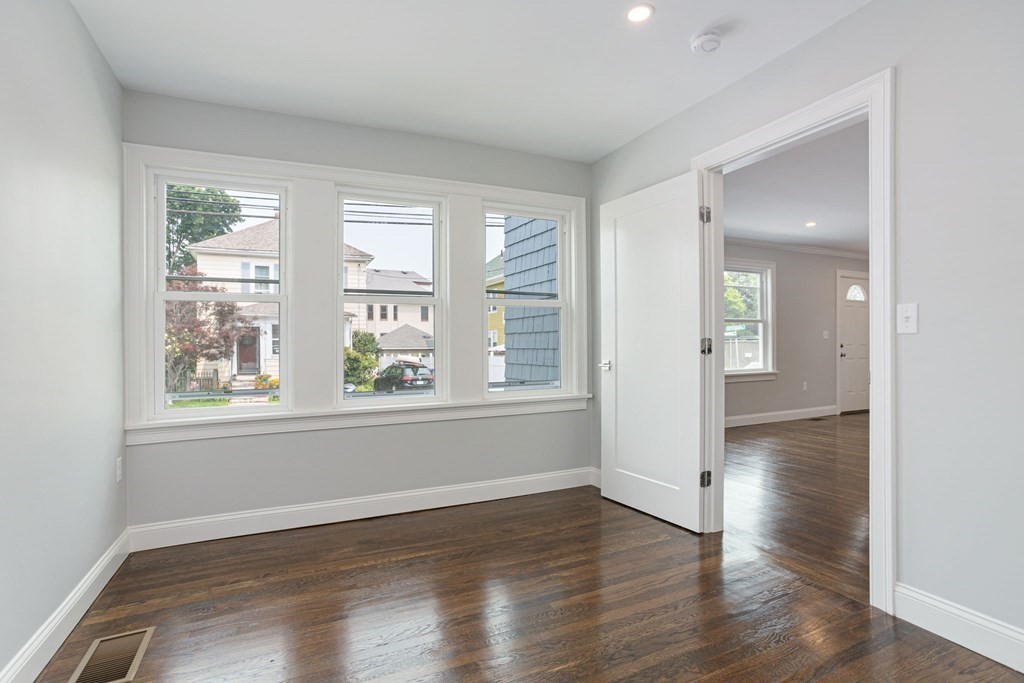 34 Brookvale Street Boston, MA 02124 - Photo 16 of 36 an empty room with wooden floor and windows