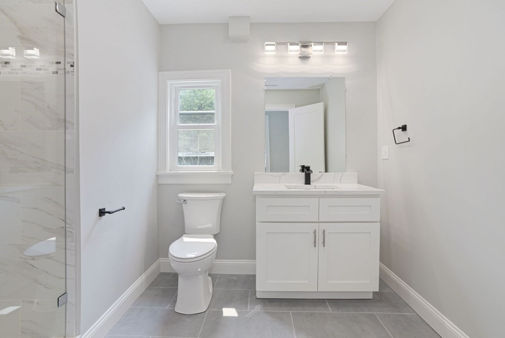 34 Brookvale Street Boston, MA 02124 - Photo 21 of 36 a bathroom with a toilet sink and mirror