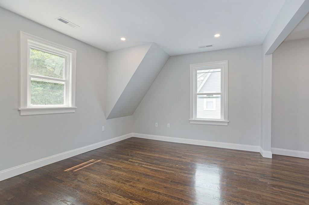 34 Brookvale Street Boston, MA 02124 - Photo 22 of 36 an empty room with wooden floor and windows