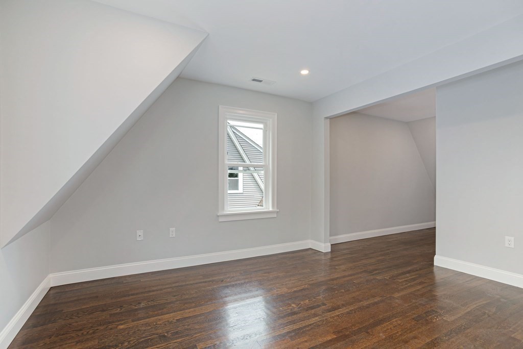 34 Brookvale Street Boston, MA 02124 - Photo 23 of 36 a view of an empty room with wooden floor and a window